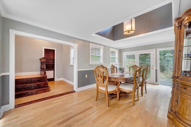 dining area featuring crown molding and light wood-type flooring