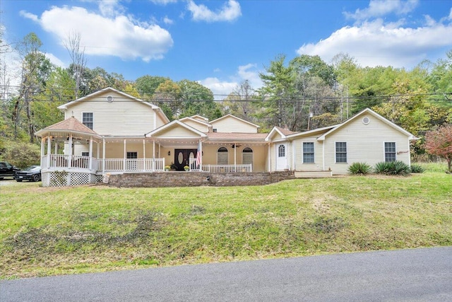 view of front of property featuring covered porch and a front lawn