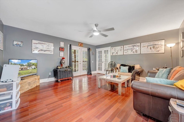 living room featuring wood-type flooring, french doors, and ceiling fan