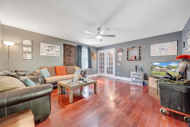 living room featuring hardwood / wood-style floors and ceiling fan