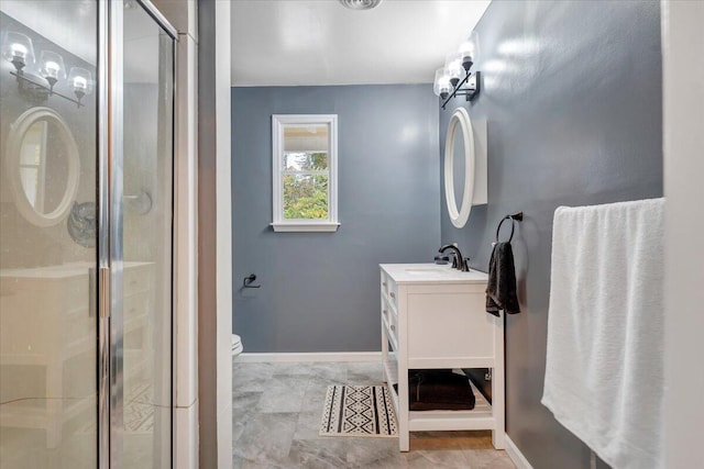 bathroom with vanity, toilet, and an enclosed shower