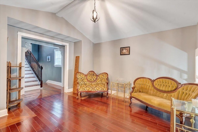 living area featuring lofted ceiling with beams and wood-type flooring