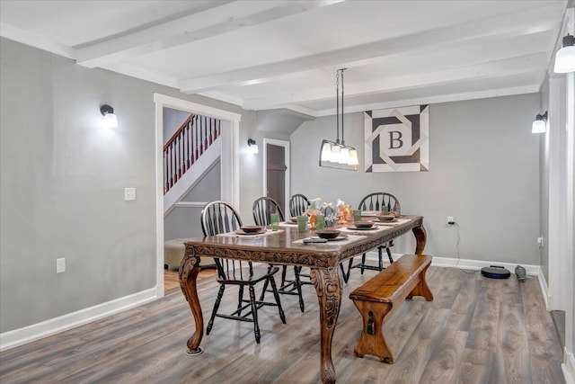 dining space with beamed ceiling and wood-type flooring