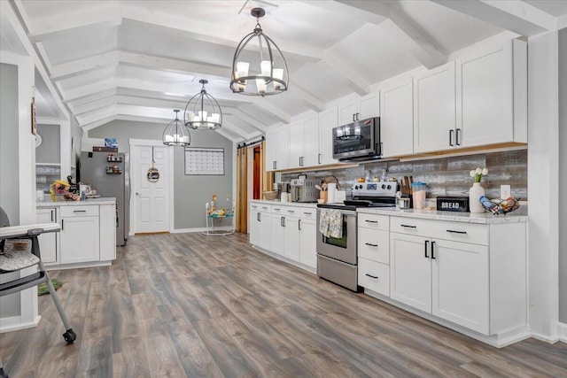 kitchen featuring vaulted ceiling with beams, white cabinetry, hanging light fixtures, stainless steel appliances, and decorative backsplash