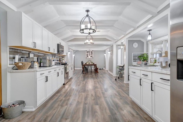 kitchen featuring stainless steel electric range oven, a chandelier, hanging light fixtures, and white cabinets