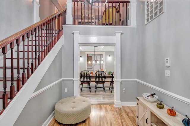 staircase featuring hardwood / wood-style floors and a notable chandelier