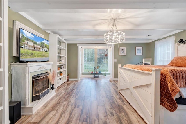 living room with hardwood / wood-style flooring, built in features, and beam ceiling