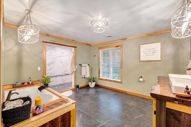 bathroom with crown molding, vanity, a bathtub, and a chandelier