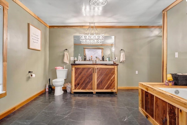 bathroom with vanity, crown molding, and toilet