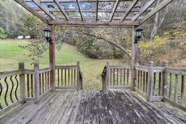 wooden terrace with a pergola and a lawn