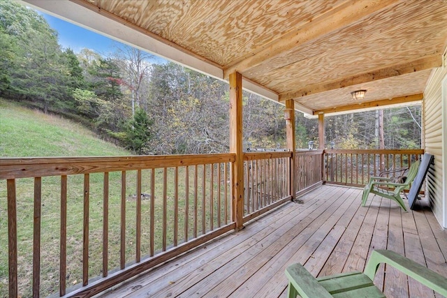 wooden terrace featuring a yard