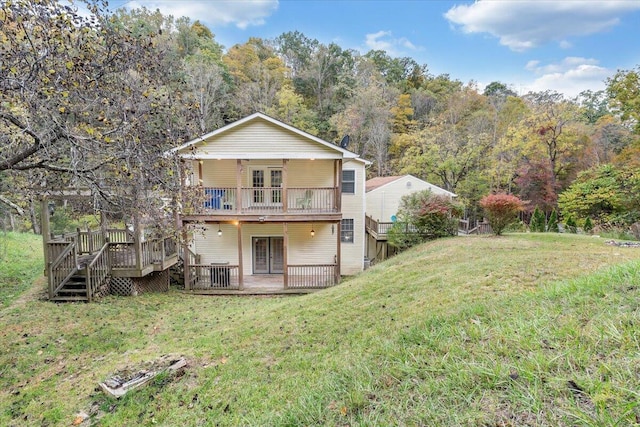 back of house featuring french doors, a yard, and a deck