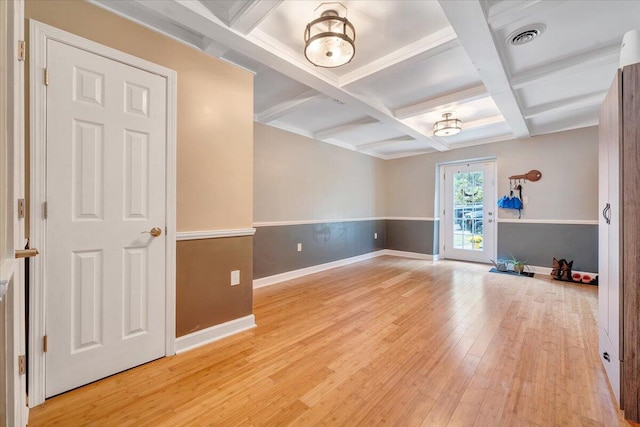 unfurnished room with beamed ceiling, coffered ceiling, and light wood-type flooring