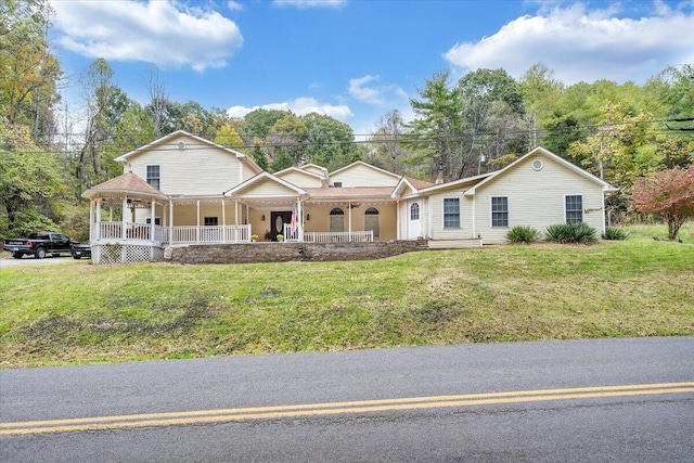 view of front of home with a porch and a front yard