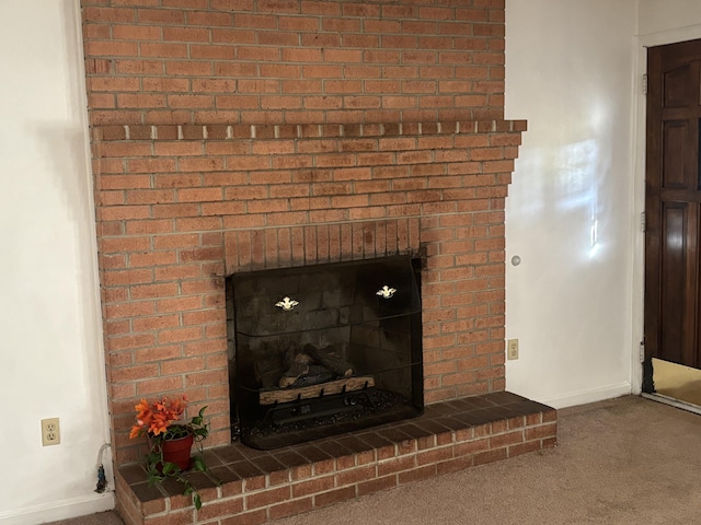 interior details with carpet and a brick fireplace