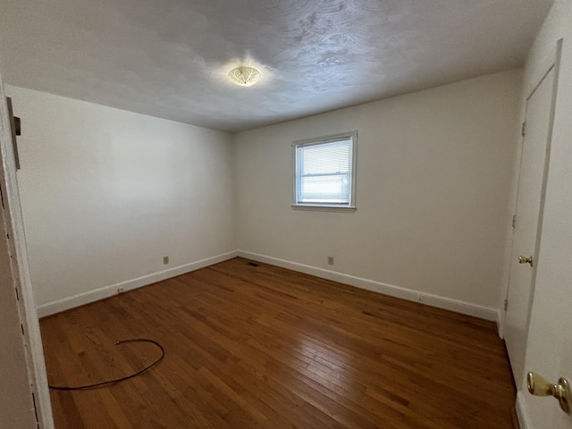 unfurnished bedroom with hardwood / wood-style floors and a textured ceiling