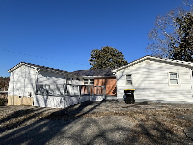 back of house with a deck