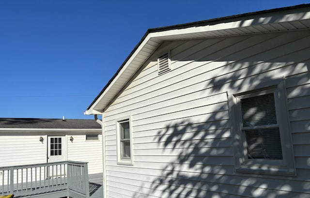 view of home's exterior with a wooden deck