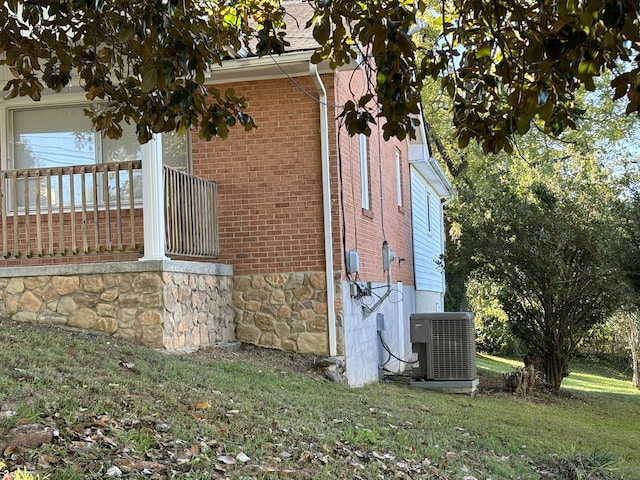 view of side of home with central AC