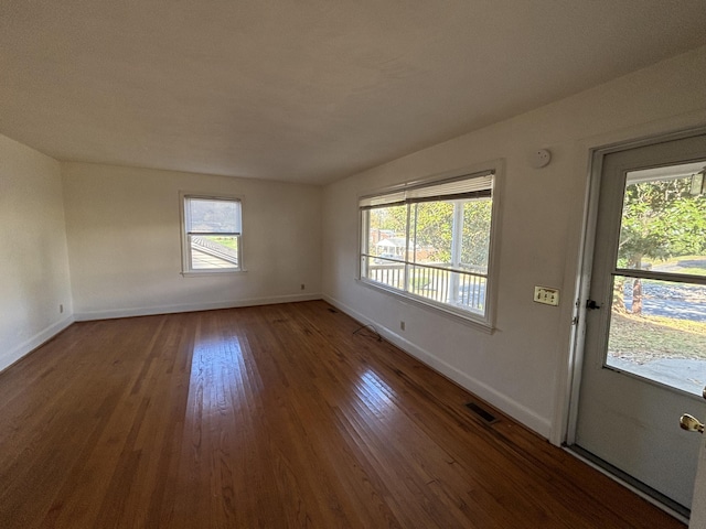 empty room featuring dark hardwood / wood-style flooring