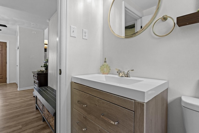 bathroom featuring hardwood / wood-style floors, vanity, and toilet