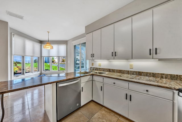 kitchen featuring white cabinets, kitchen peninsula, stainless steel dishwasher, and hanging light fixtures