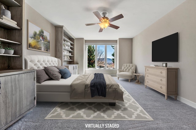 bedroom featuring ceiling fan and dark carpet