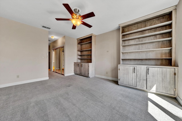 unfurnished living room featuring ceiling fan and light carpet