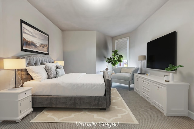 bedroom featuring light colored carpet