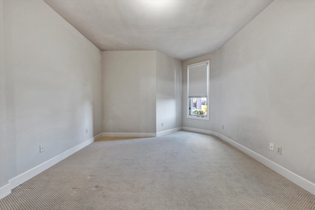 spare room with light colored carpet