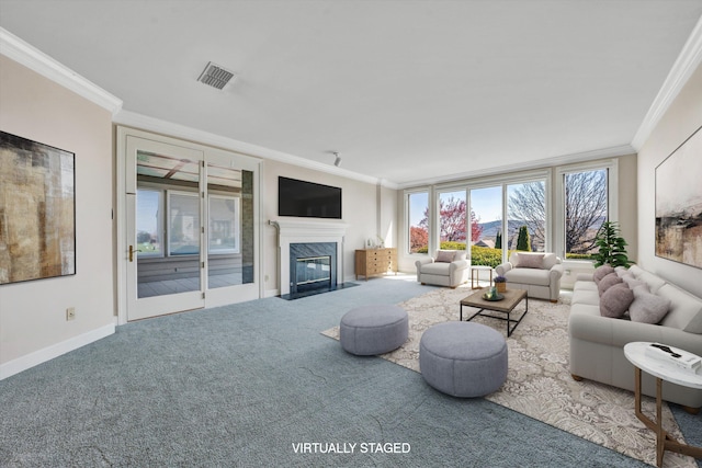 living room featuring carpet flooring, crown molding, and a wealth of natural light