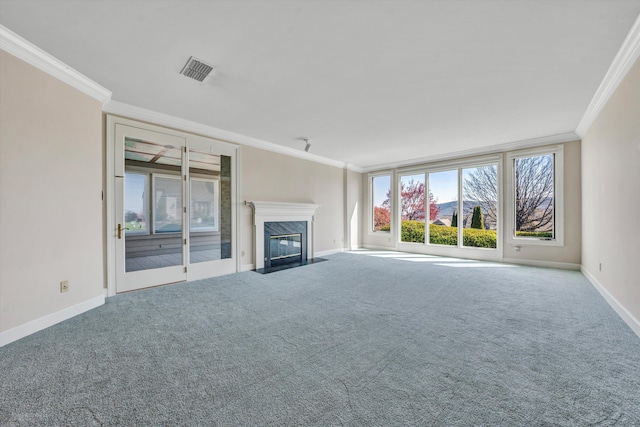 unfurnished living room featuring a wealth of natural light, a high end fireplace, and ornamental molding