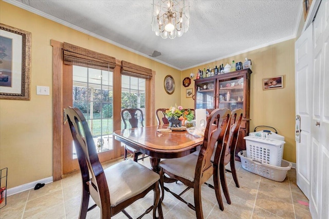 dining area featuring a chandelier, a textured ceiling, and crown molding