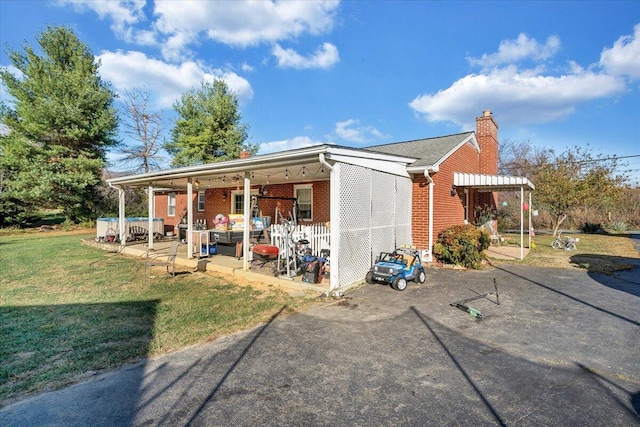 exterior space featuring a lawn and a patio