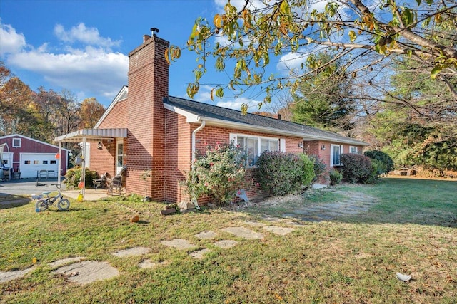 view of side of property featuring a garage and a yard