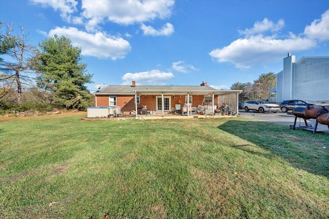 rear view of property with a patio area and a yard