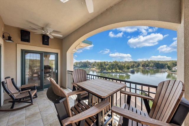 balcony featuring a water view and ceiling fan