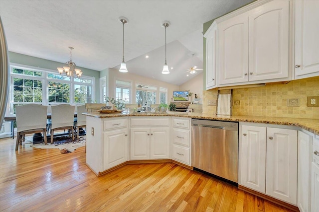 kitchen featuring lofted ceiling, kitchen peninsula, decorative light fixtures, white cabinetry, and dishwasher