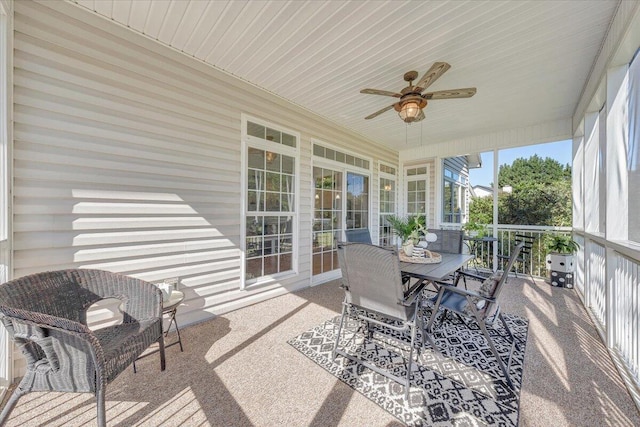 sunroom featuring ceiling fan