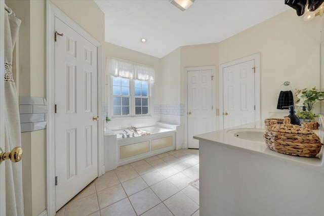 bathroom with a bathtub and tile patterned flooring