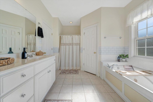 bathroom with a tub to relax in, tile patterned flooring, and vanity