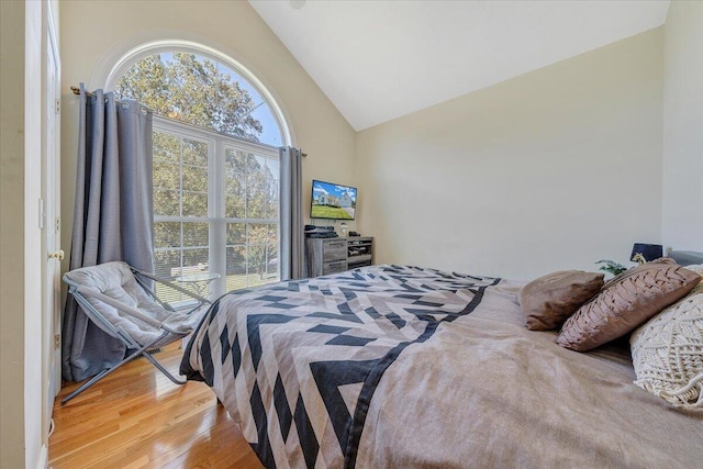 bedroom featuring lofted ceiling and light wood-type flooring