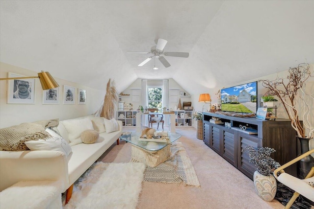 carpeted living room featuring ceiling fan and vaulted ceiling