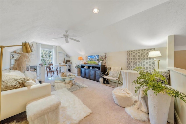 carpeted living room with lofted ceiling, ceiling fan, and a textured ceiling