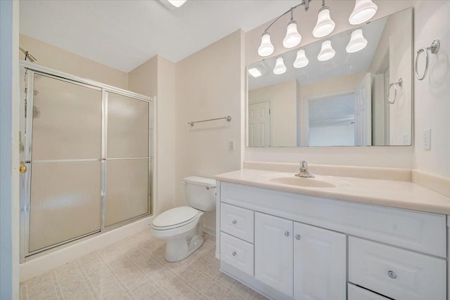 bathroom featuring walk in shower, vanity, and toilet