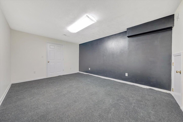 carpeted spare room with a textured ceiling