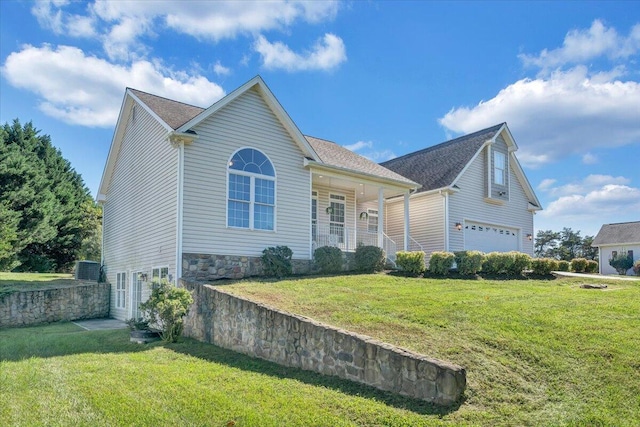 view of front of property with a garage and a front lawn