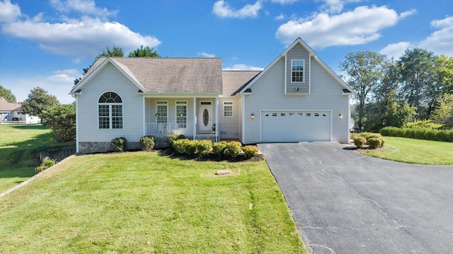 view of front of house featuring a front yard, a garage, and covered porch