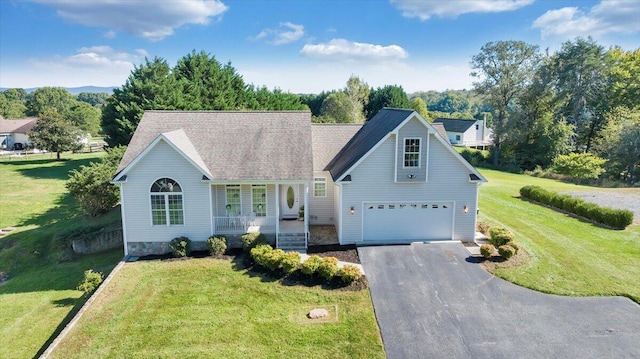 view of front of house featuring a garage, a front lawn, and covered porch