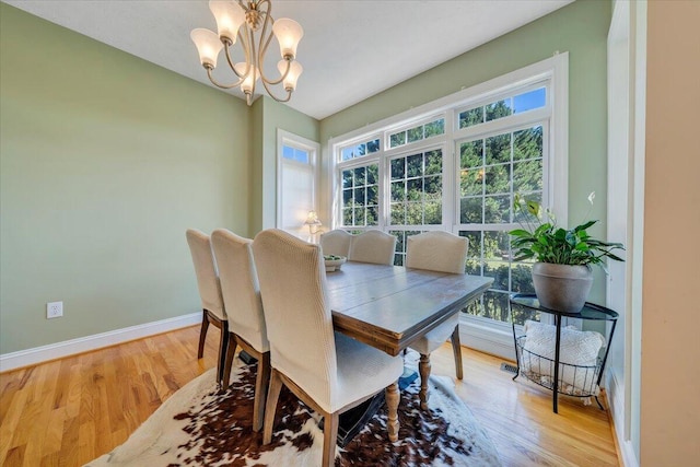 dining area featuring an inviting chandelier, light hardwood / wood-style floors, and a wealth of natural light